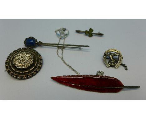 A Victorian silver horseshoe brooch, a silver and enamel leaf brooch, three other brooches and a pendant