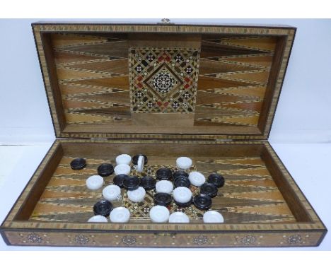 An Anglo-Indian marquetry chess and backgammon board with gaming pieces