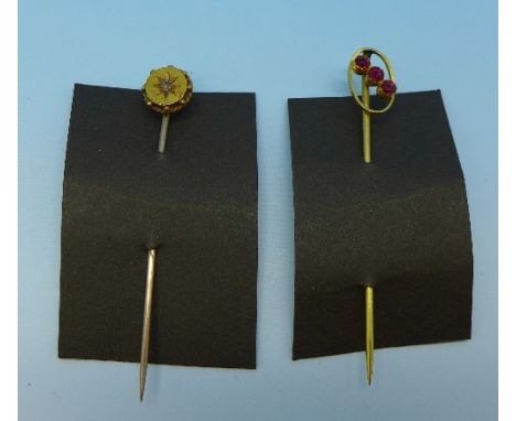 Two stick pins; 15ct gold set with a diamond and 9ct gold set with red stones