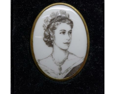 A Royal Worcester gilt metal framed black and white Coronation of HM Queen Elizabeth II oval portrait brooch, boxed