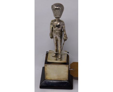 A Goldsmith &amp; Silversmith Company silver model of a Scots Guard on wooden base, H.15, H.23 with base 