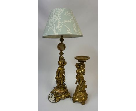 A Gilt Metal &amp; Onyx Table Lamp, Modelled as a nude Putti child, 50cm high, with shade, fitted for electricity, also with 