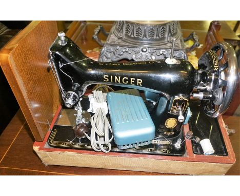 A Vintage Singer Portable Sewing Machine, Number EM 735483, in travel case 