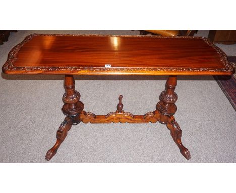 A Victorian Style Stained Hardwood Sofa Table, With rectangular top raised on turned columns and four scroll feet, 71cm high,