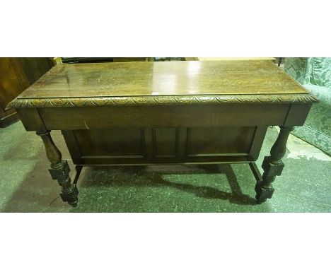 A Vintage Oak Leaf Cabinet, circa 1930s, with a door to each back corner, raised on turned legs, 86cm high, 150cm wide, 60cm 