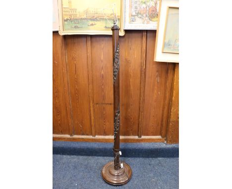 Chinese carved hardwood standard lamp, 162 cm tall, with a beige coloured shade. 