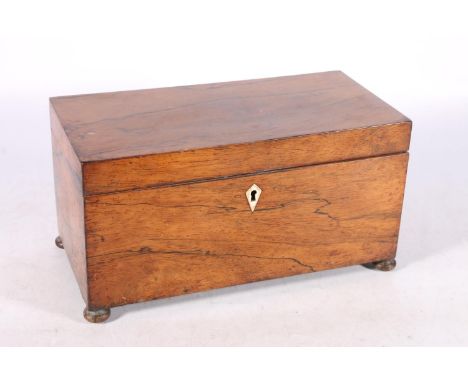 Antique rosewood tea caddy, the hinge top opening to reveal interior with two tea cannisters and mixing well, raised on bun f