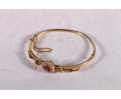 Victorian yellow metal bangle set with seed pearls and faceted red stones, 10g gross. #368 