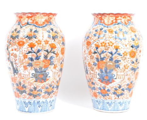 A pair of late 19th century Japanese Imari urn vases. The vases featuring blue and red floral motifs and patterns&nbsp; with 