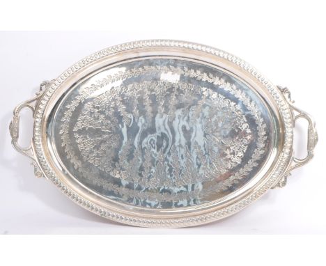 A 20th century silver plated twin handled serving tray. The tray having foliate design to surface with gadrooned edge. Measur