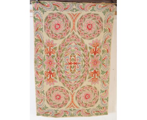 An antique crewel work wall hanging of fine quality depicting floral and foliate work as well as scrolls and wheel patterns i