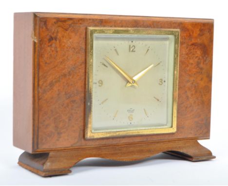 A mid 20th century in the manner of Art Deco, Elliot of London burr walnut mantle clock. The clock having a square face marke