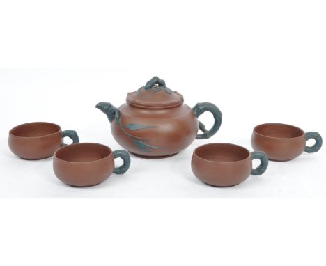 A vintage 20th century Chinese Yixing terracotta / stoneware tea service comprising of teapot alongside a set of four teacups