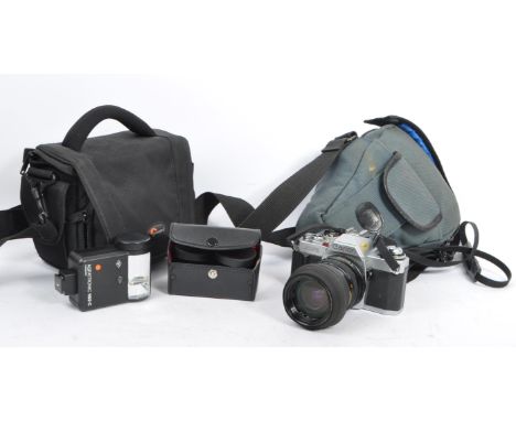 A vintage 20th century Canon AV-1 film camera with Tokina lens. Accompanied by carry cases, manual, and flash.&nbsp;