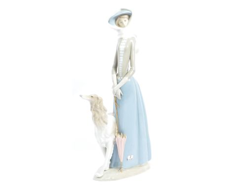 Lladro - A large vintage 20th century Spanish porcelain Lladro figurine in the form of a gentlelady holding parasol with pet 