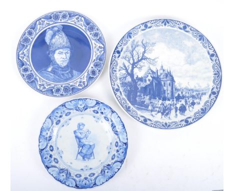 Three early 20th century continental delftware blue &amp; white chargers, to include one featuring a young girl with a light 