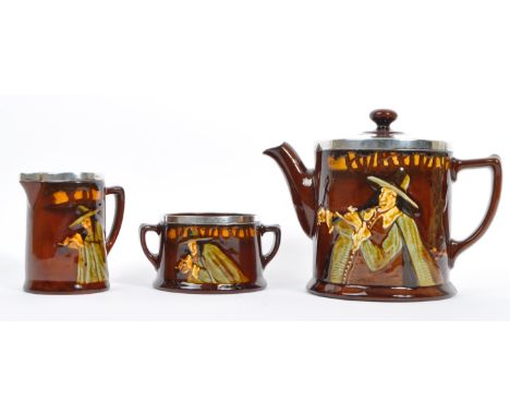 Royal Doulton - An early 20th century circa 1920s Royal Doulton pied piper pattern part tea service. Comprising of teapot / c