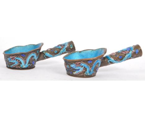 A pair of early 20th century circa 1920s Chinese enamelled copper silk irons. Each having blue enamel interior with enamelled