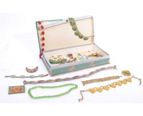 A varied range of 20th century brooches, necklaces in a variety of materials which includes an item of amber. All contained w