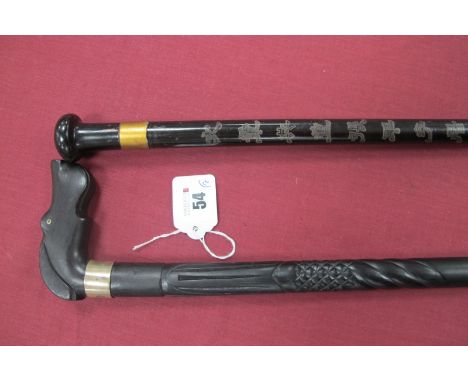 An Ebony Dog's Head Walking Cane, white metal collar, part engraved on shaft, brass/steel tip, 87cm long and another stick, w