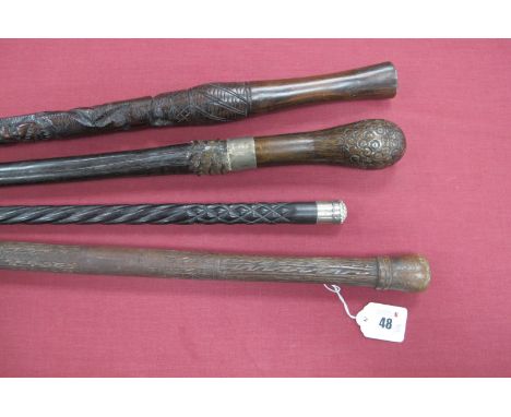 A Hardwood Stick, with silver ferrule, and three others with various decoration, all approximately 90cm long. (4)