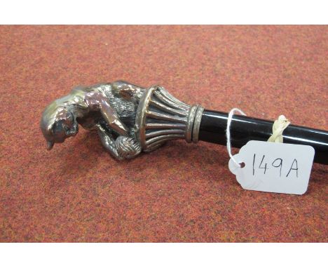 A Silver Handled Walking Cane, with cat playing with a ball of string, cat and base, 10cm long, ebonised cane with brass tip,