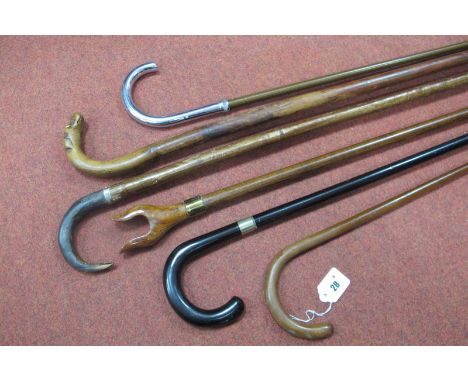 A Softwood Stick, bent handle in the form or a dogs head, a Chinese stick with calligraphy writing down shaft, a metal cane, 