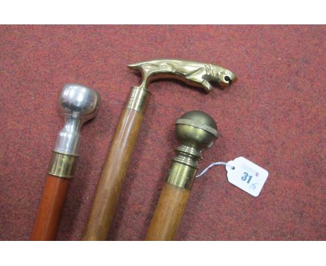 A Brass Top Cane with Compass in Handle, a two piece sectional, and a cane with brass handle as a jaguar, and another white m