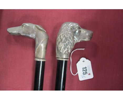 A White Metal Top Walking Stick with greyhounds head, and another cast as a spaniel, each 92cm long. (2)