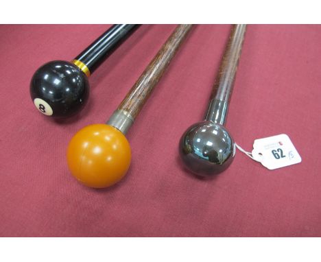 A No 8 Ball Modern Collapsible Four Piece Stick, 93cm long, a white metal two piece cane, brass tip 85cm long, and another wi