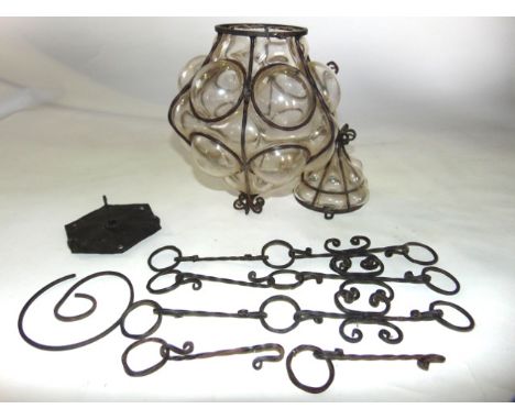 A moulded glass hall lantern set within a twisted ironwork frame together with chains etc