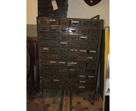 A vintage floor standing industrial bank of 66 steel small index drawers, 3ft wide x 143cm high approx