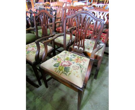 Four Hepplewhite style open elbow chairs, the shield shaped backs with pierced vase shaped splats over drop in floral tapestr