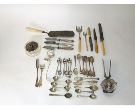 A collection of silver plated flatware including serving forks, a glass bowl with silver cover, etc, together with an unusual