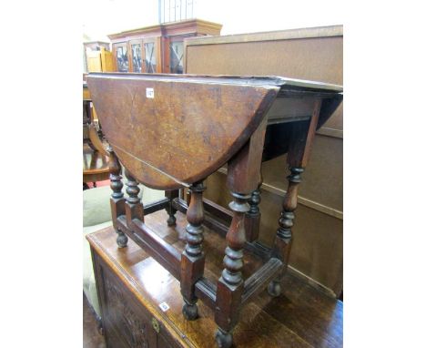 A small Georgian oak gate leg table raised on eight baluster shaped supports, 80 cm long approx maximum