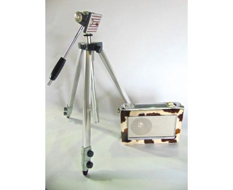 A vintage Bush transistor radio model TR130 in a simulated pony skin case together with a camera tripod and a peavey drum 