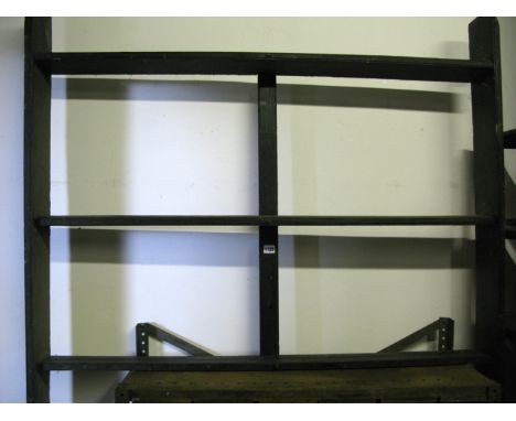 A vintage stained pine wall mounted open plate rack, with three fixed shelves and moulded detail
