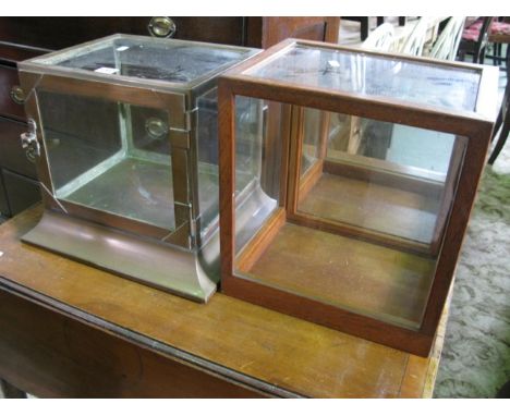 A small unusual vintage copper framed table/counter top cabinet of square cut form with glazed panelled surround and single d