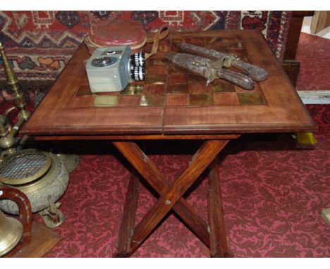 A folding hardwood games table inlaid with brass, an Eastern knife and fork set and a vintage Crown cine camera