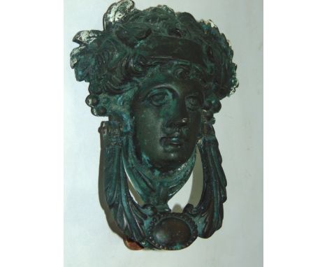 A 19th century cast brass door knocker in the form of a classical female head