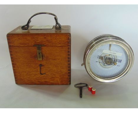 A pigeon racing clock in a chromium case and oak container