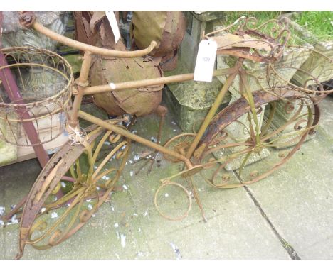 A weathered novelty card planter in the form of a bicycle together with two further novelty garden ornaments of sheet tin con