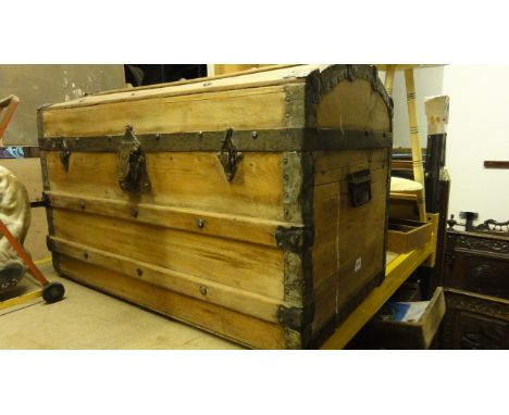 A Victorian pine, lathe and steel banded domed topped travelling trunk/chest with side carrying handles