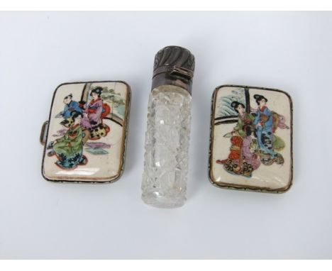 A Japanese ceramic two sectional buckle with hand painted character detail and plated mount and a silver topped scent bottle