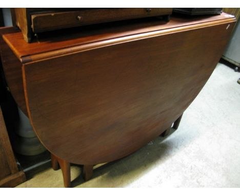 A narrow (when closed) teak oval drop leaf dining table with gate leg action and pierced supports, (probably G plan), to seat