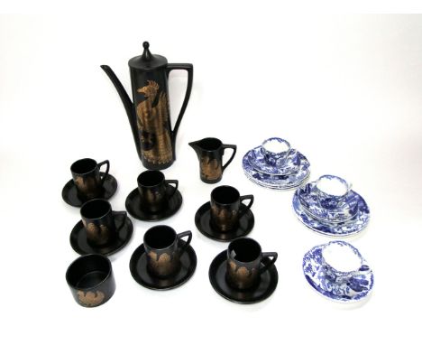 A collection of Portmeirion Phoenix pattern coffee wares designed by John Cuffley with gilt decoration on a black ground comp