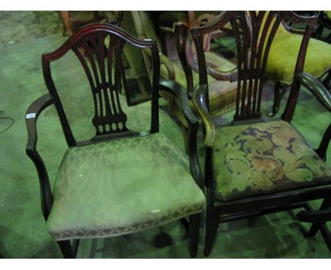 Two Georgian open elbow chairs in the Hepplewhite style with pierced combed splats, one with carved detail and tapestry seat