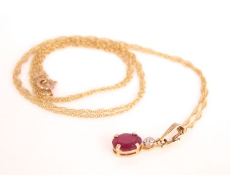 A ruby and diamond chip pendant in 10k gold marked Mexico 1g 