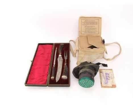 A 19th century cased set of carving tools with silver collars and antler handles together with a cased gas mask with instruct