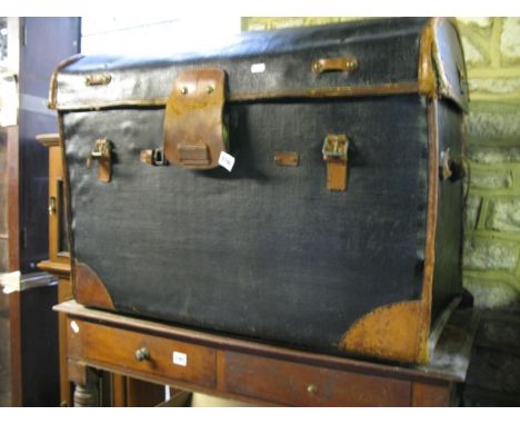 A vintage wicker encased fibre and tan leather re-enforced domed top travelling trunk